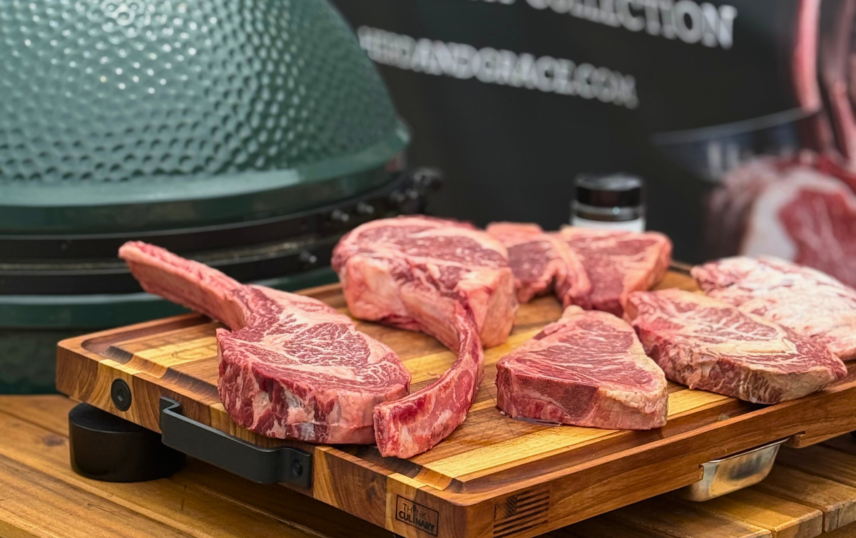 Raw steaks on a wooden cutting board 